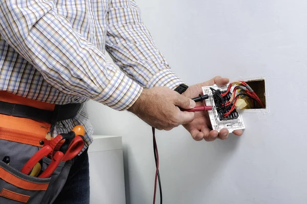 Electrician repairing electrical outlet